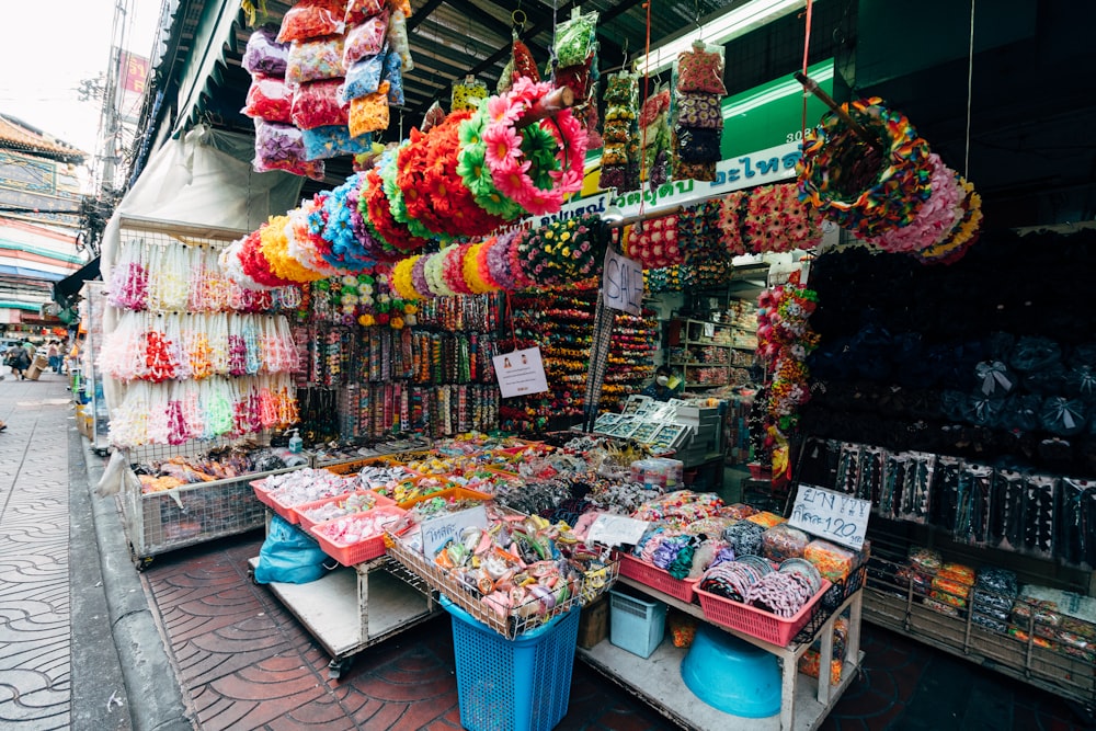 a street with a store full of colorful items