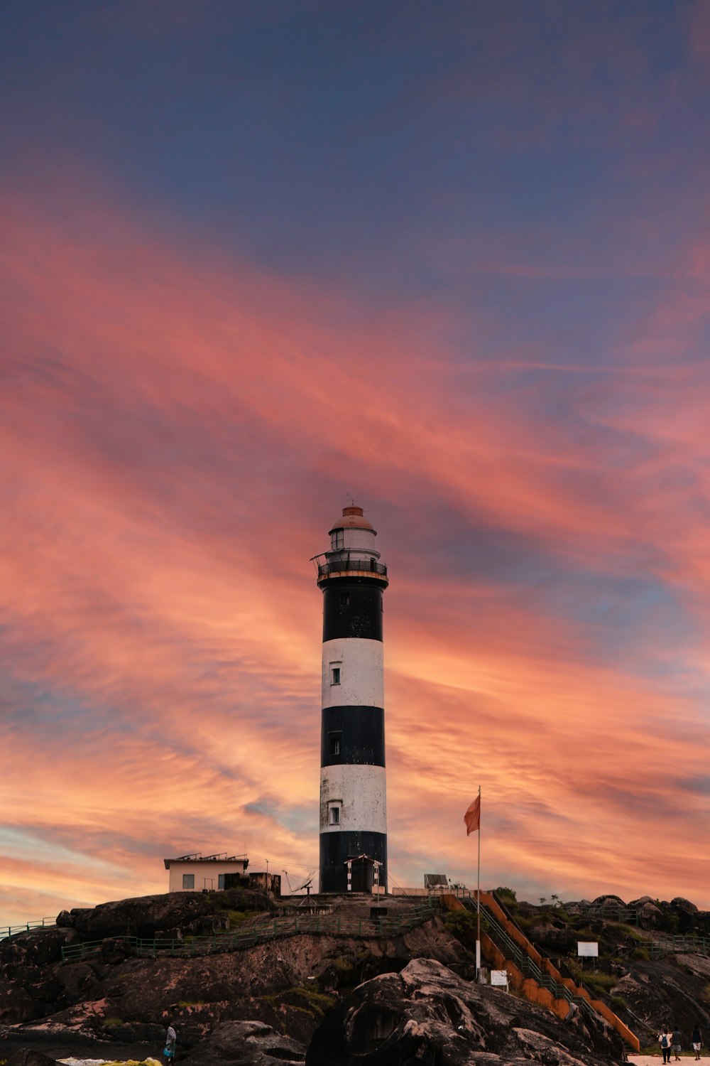 a lighthouse on a rocky hill