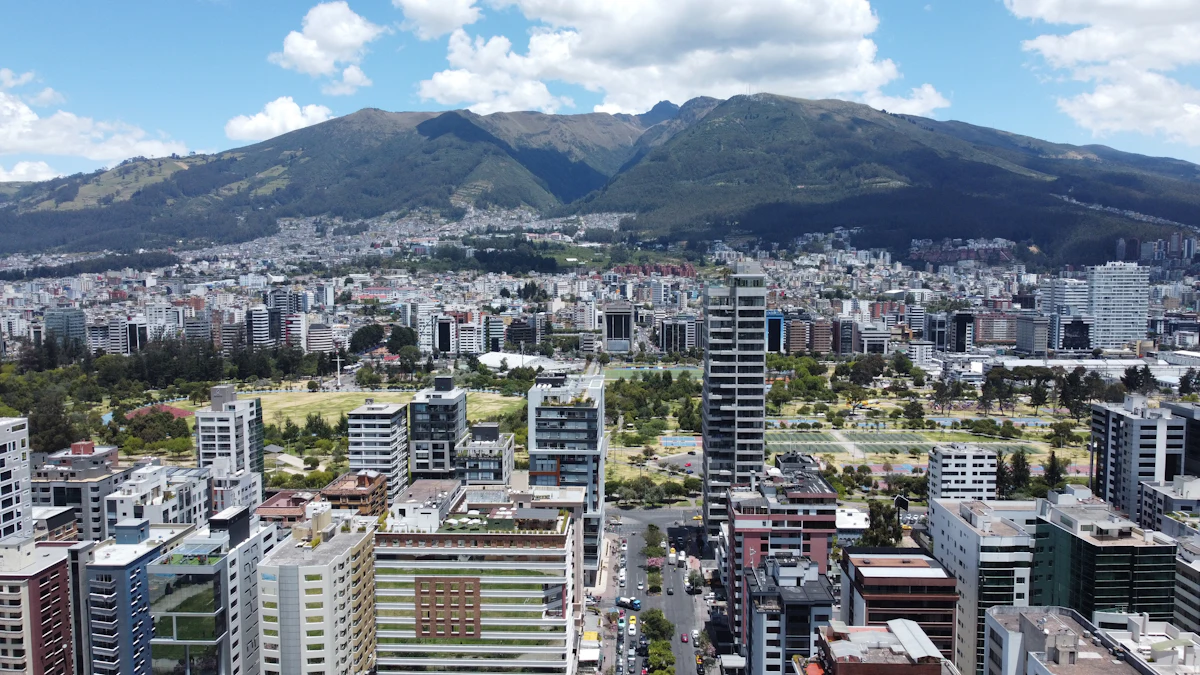 La Sierra del Ecuador: edificios modernos junto a un parque, con las montañas al fondo