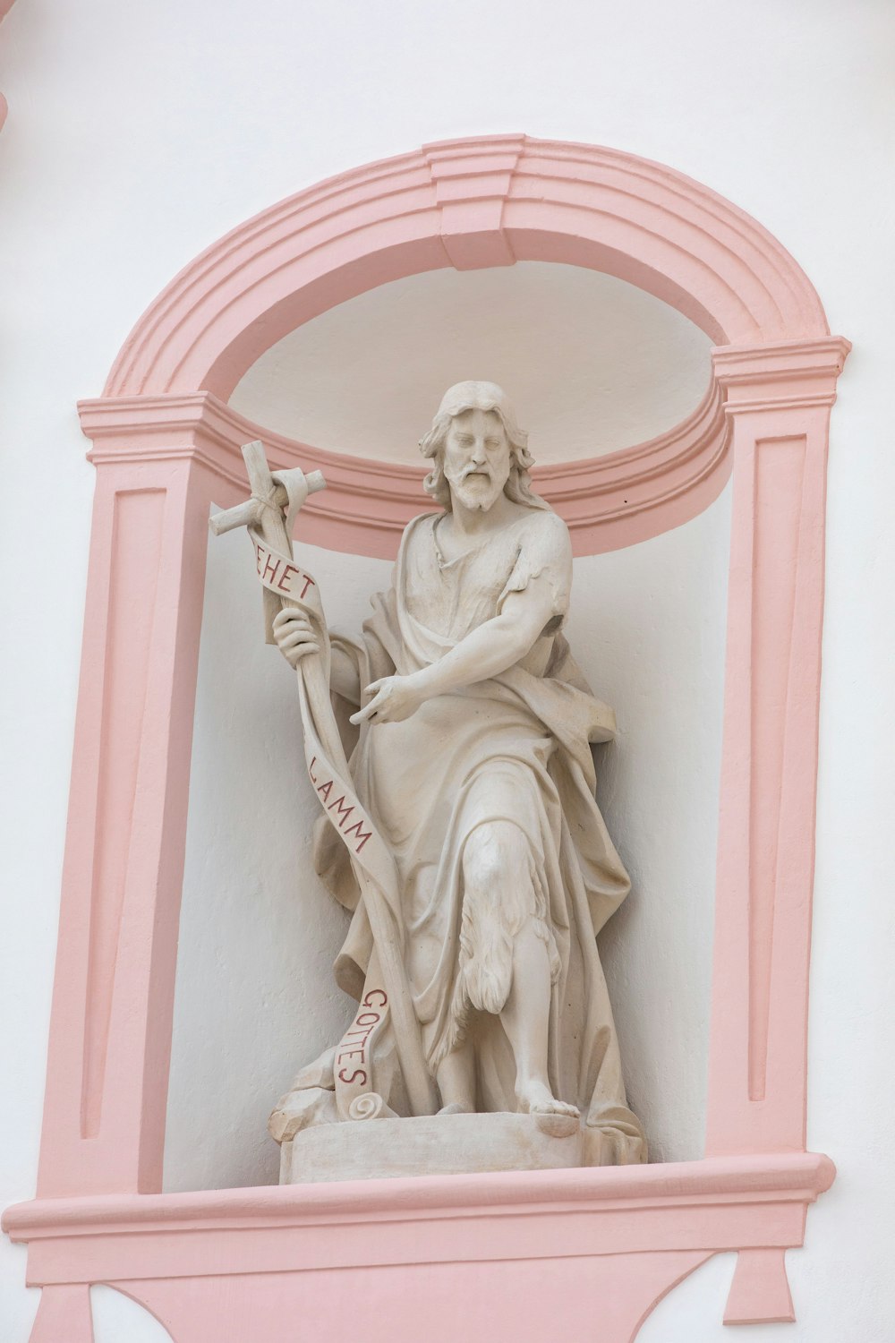 a statue of a person holding a staff