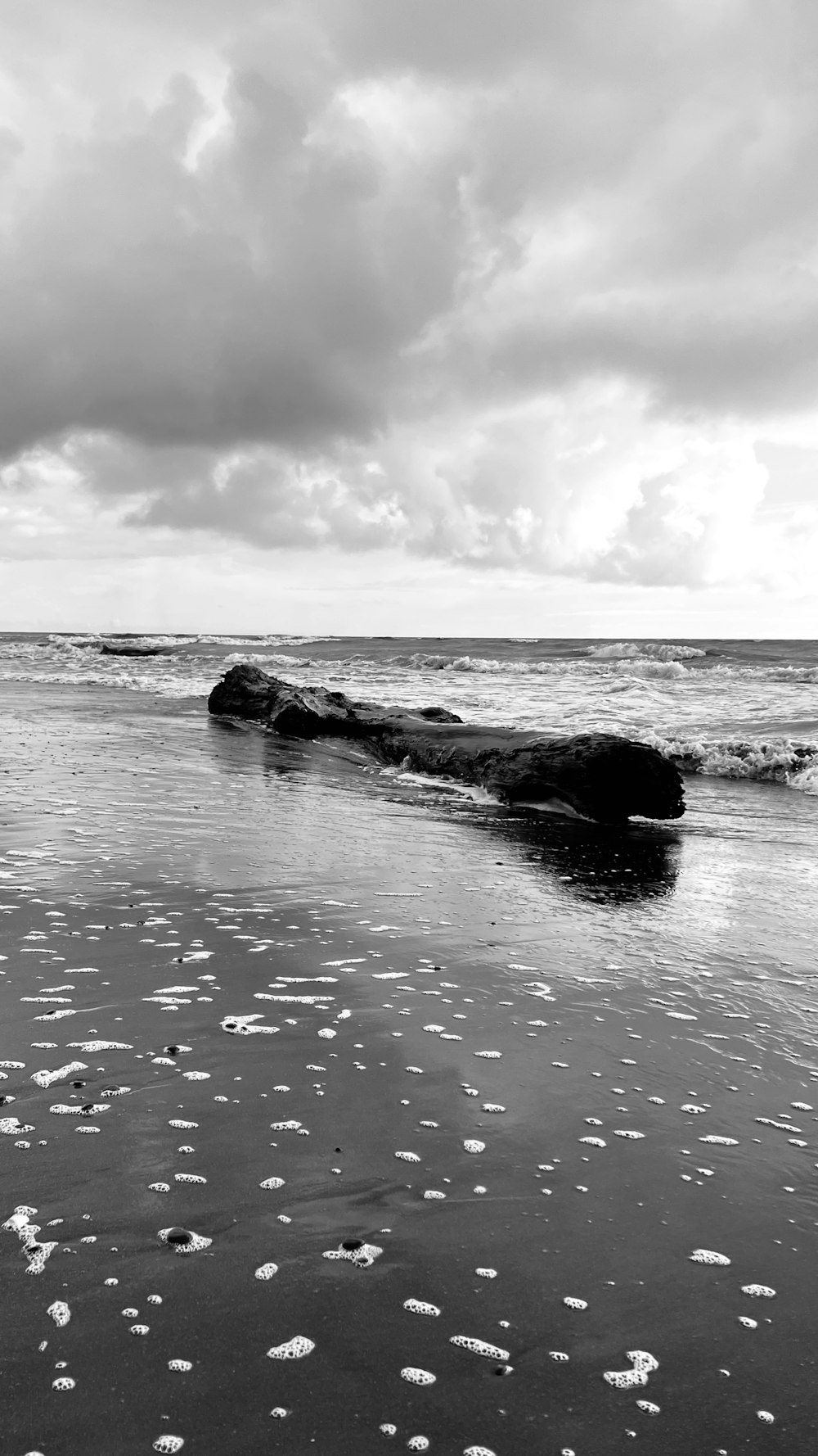 a rocky beach with waves crashing on it