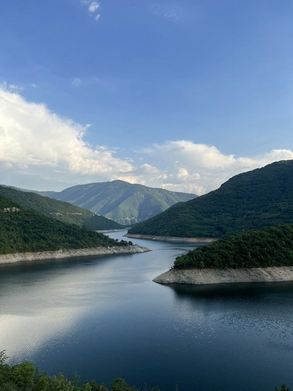 a river with mountains in the background