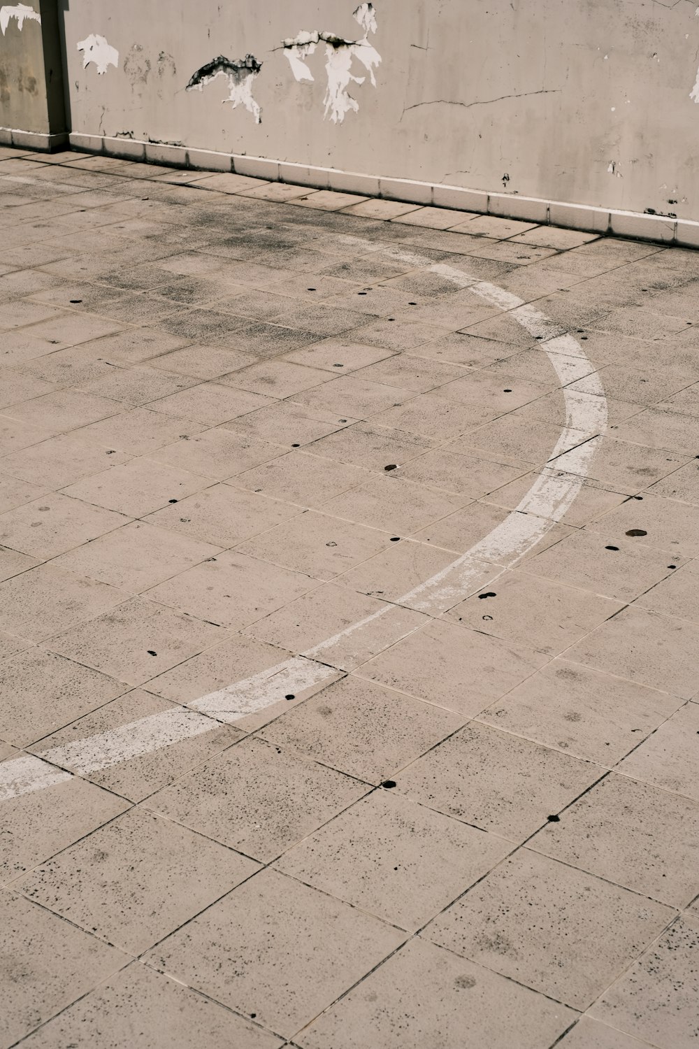 a concrete floor with a white wall