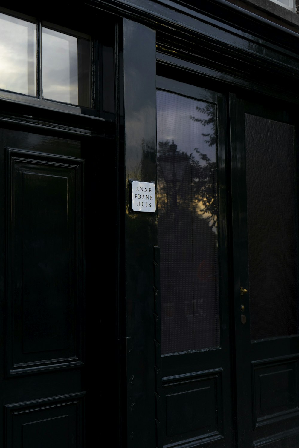 a black door with a sign on it