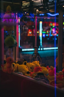 a group of stuffed animals in a room with colorful lights