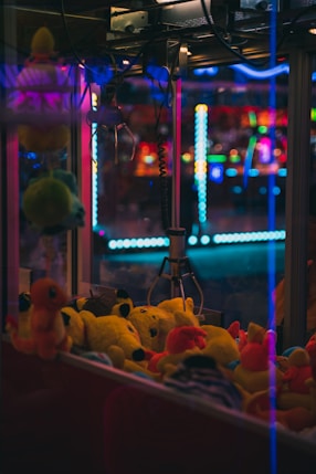 a group of stuffed animals in a room with colorful lights