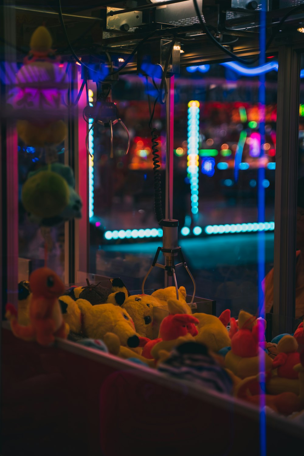 a group of stuffed animals in a room with colorful lights
