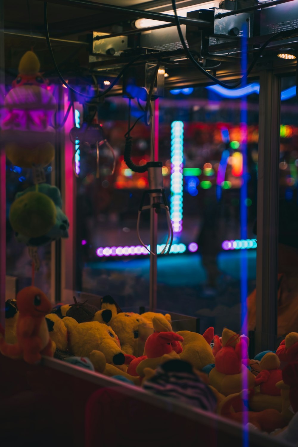 a group of stuffed animals in a room with a stage and lights