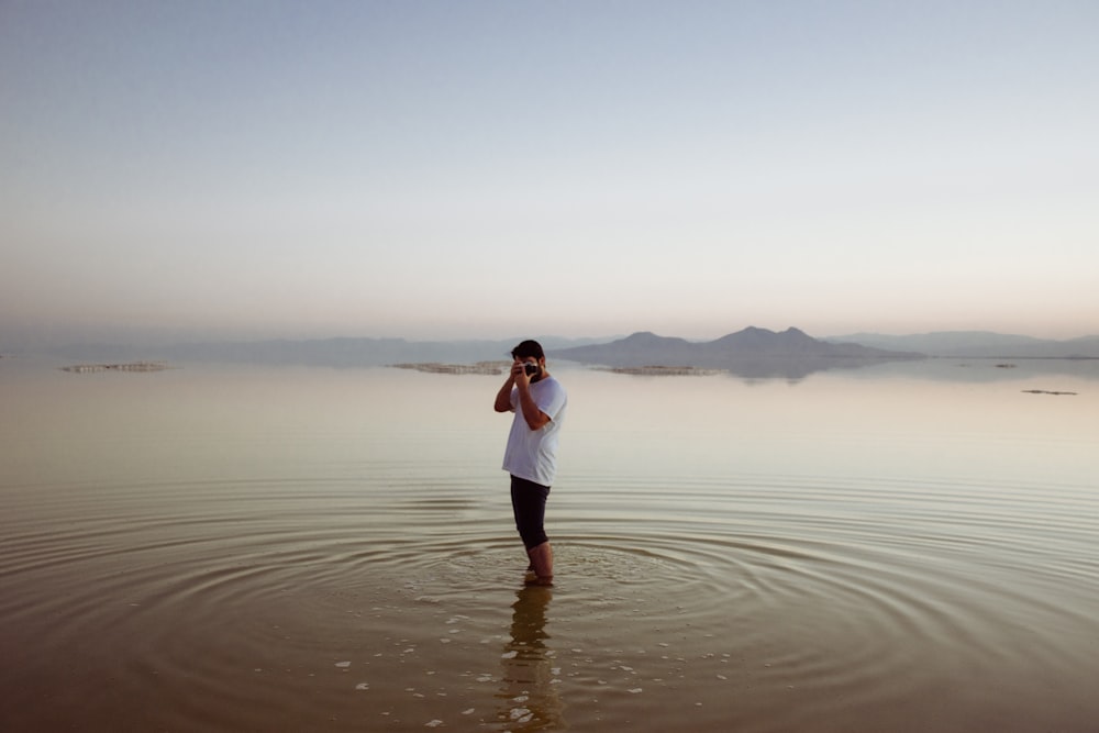 a man holding a woman on a beach