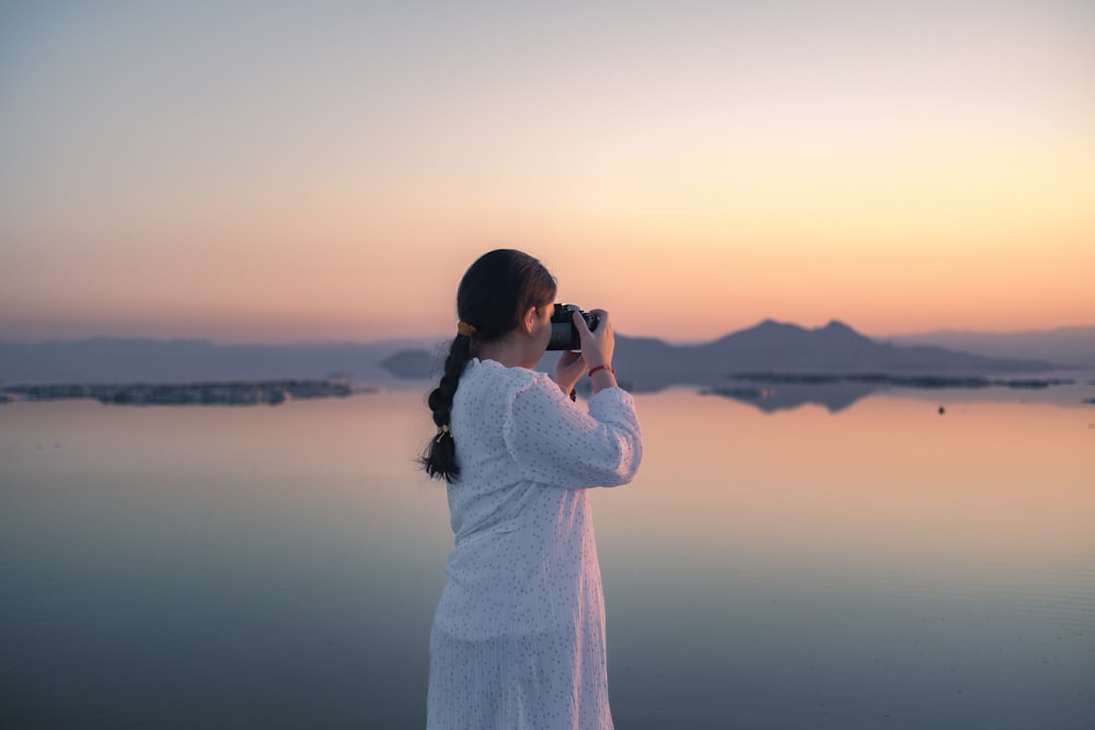 a person taking a picture of the water