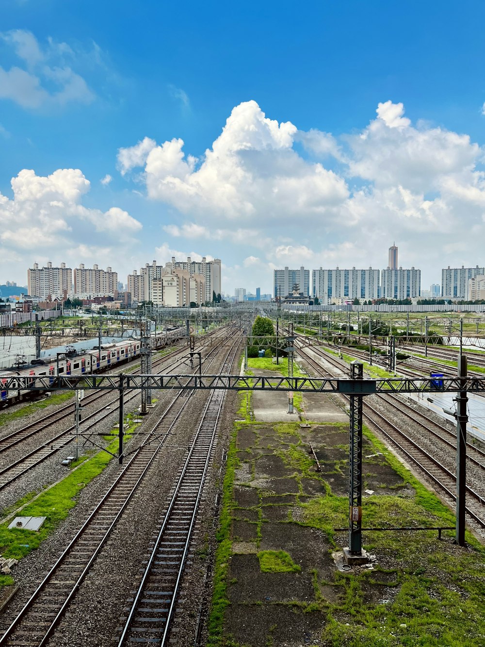 train tracks with buildings in the background