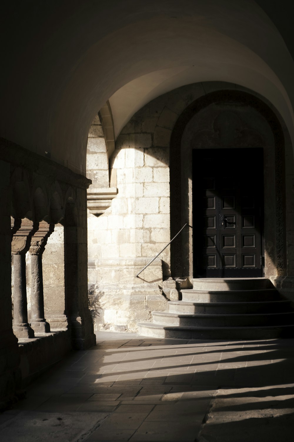 a stone building with a door and stairs