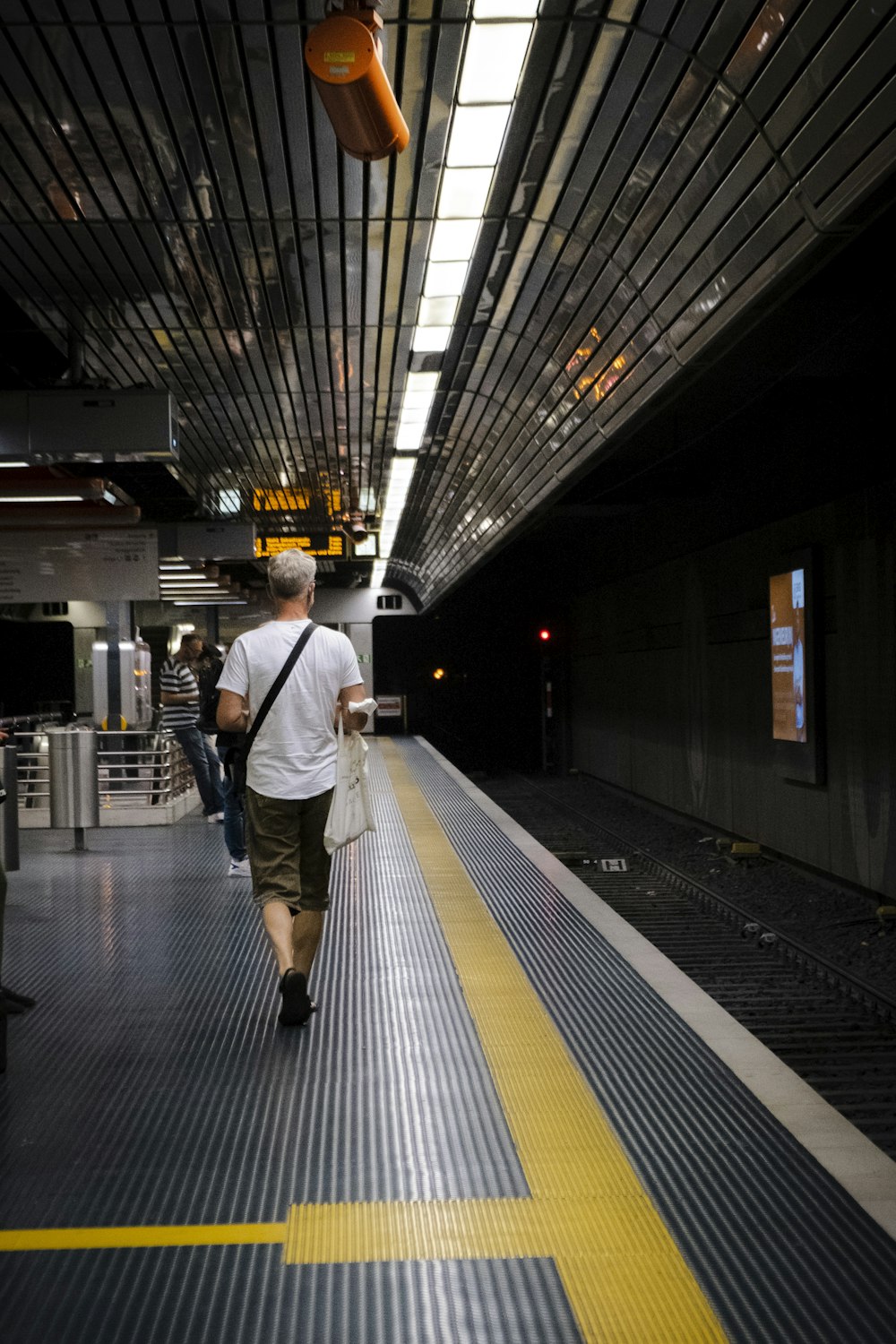 a man walking down a train platform