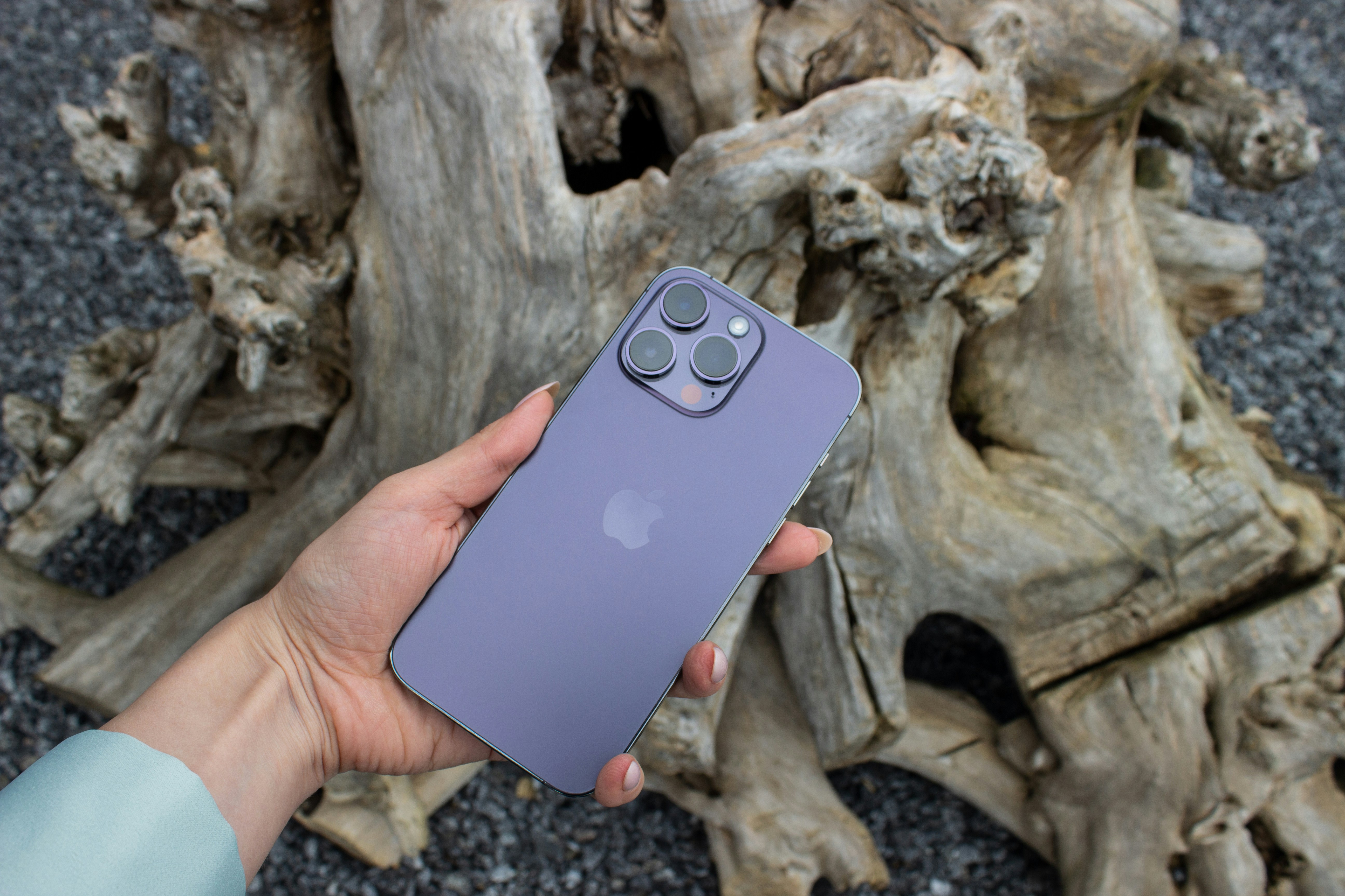 a hand holding a purple game controller