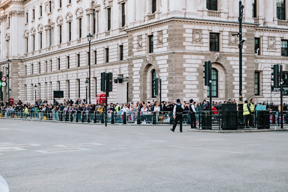 a group of people standing on the side of a street