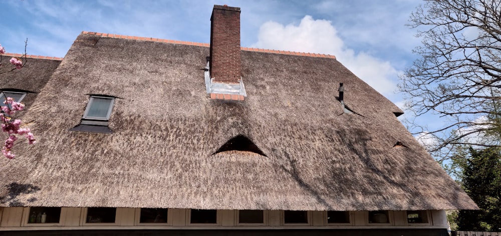 a large brown building with a chimney