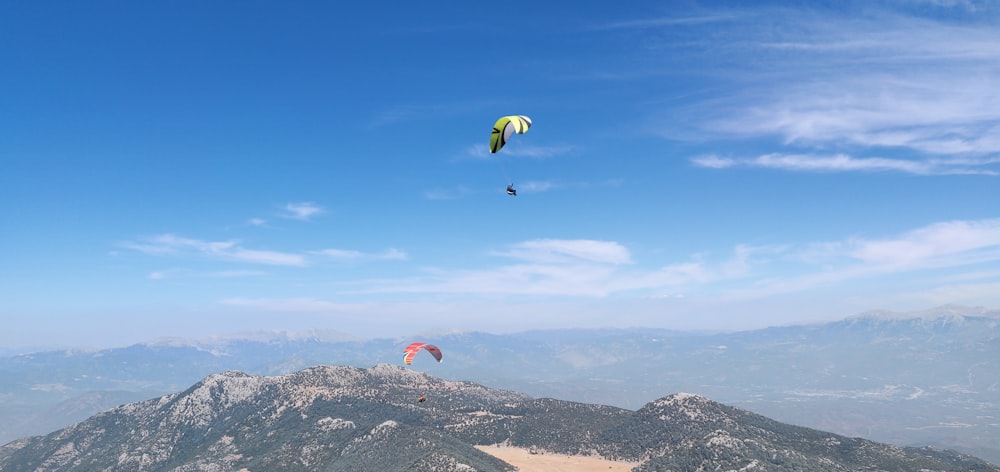 a couple people parachuting