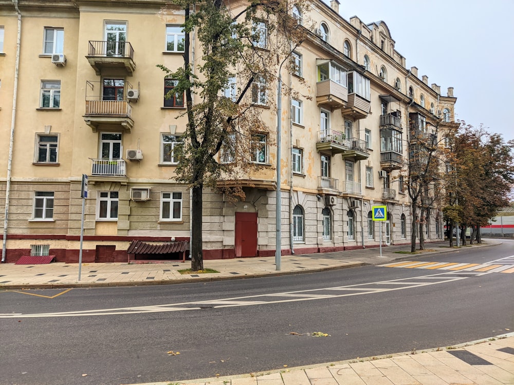 a street with trees and buildings on the side