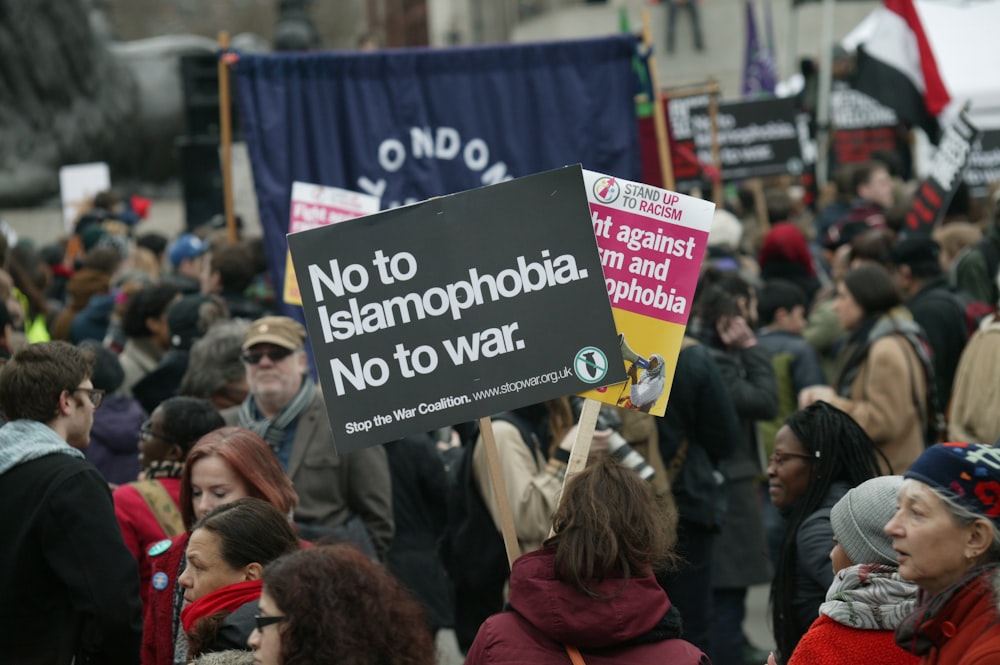 a crowd of people holding signs