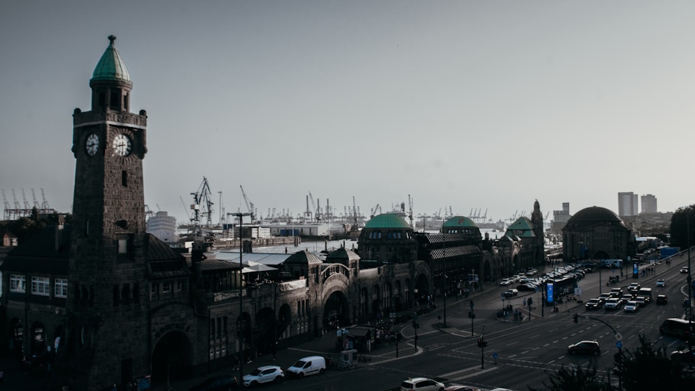 a large clock tower stands over a city