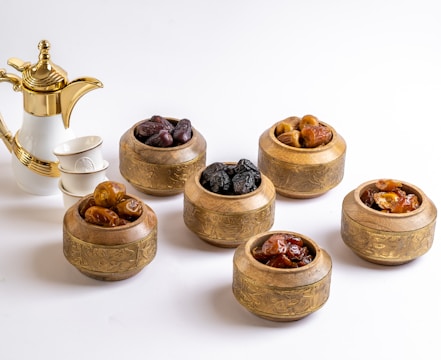 a group of small wooden bowls with brown objects in them