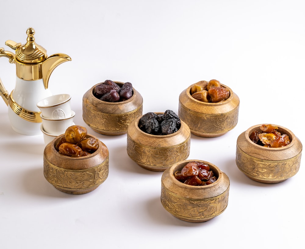 a group of small wooden bowls with brown objects in them