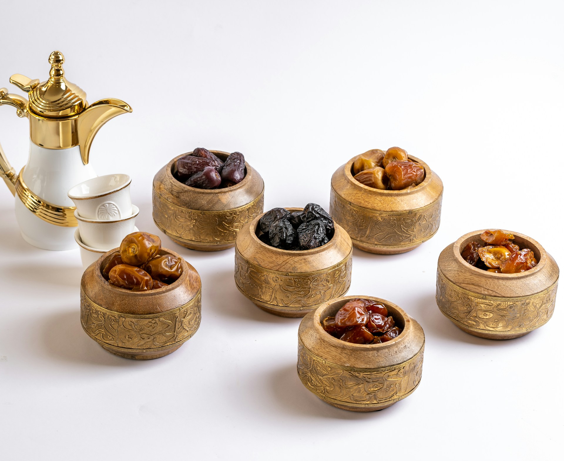 a group of small wooden bowls with brown objects in them