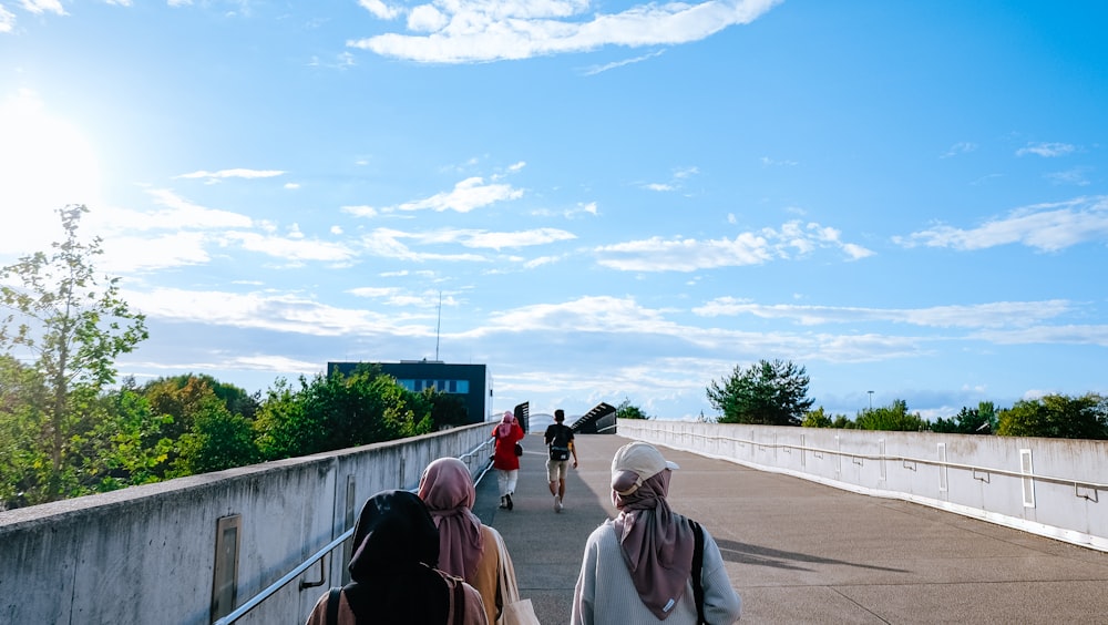 a group of people walking on a bridge