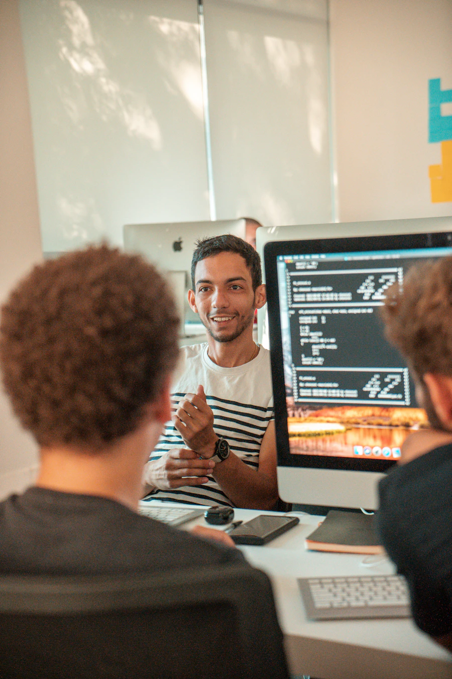 Prospective student comparing program costs on a laptop with a notebook open