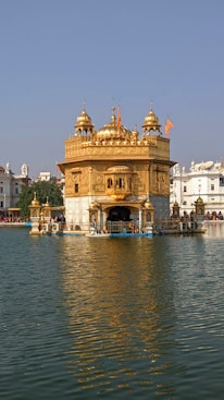 Harmandir Sahib with a gold roof and a gold domed roof surrounded by water
