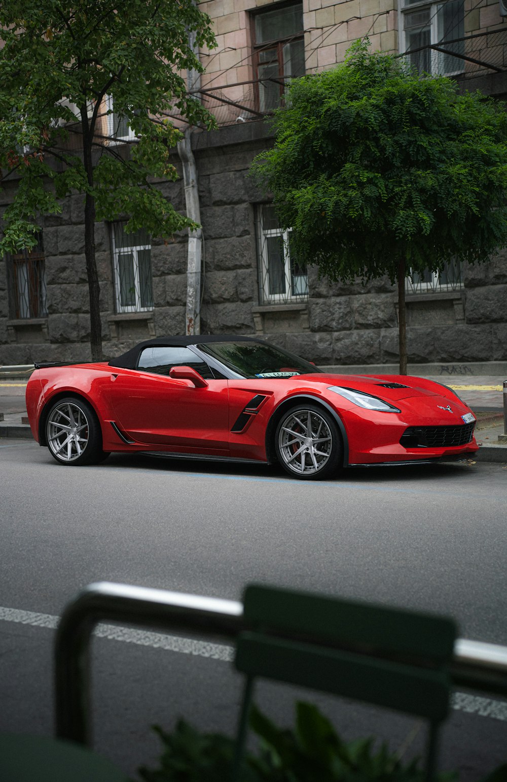 a red sports car parked on the side of a road