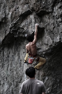 a man climbing a rock wall