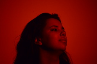 A dynamic shot of a contestant posing confidently with a subtle smile, illuminated by soft golden lighting.