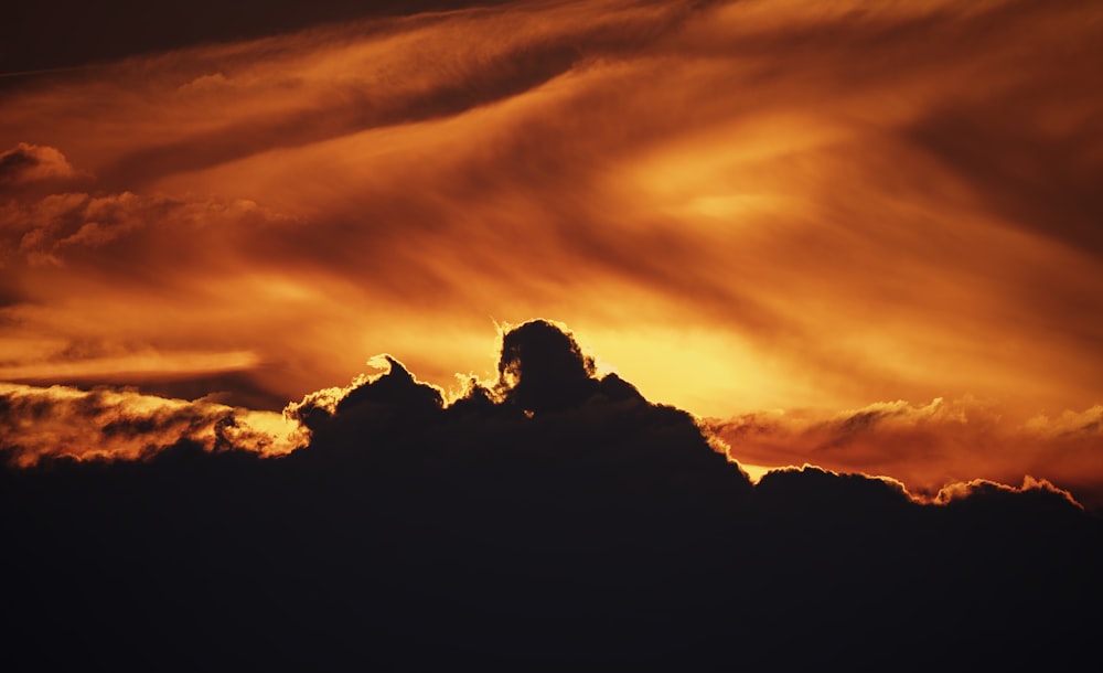 a sunset over a mountain