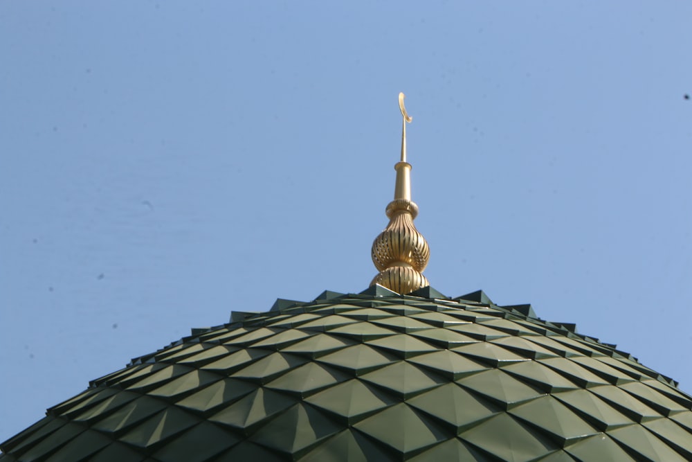 a gold statue on top of a building
