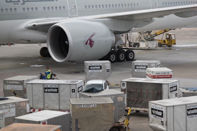 Import/Export air freight - a Qatar Airways airplane is being loaded with cargo
