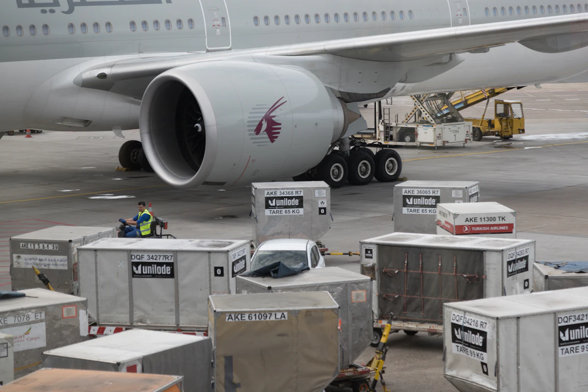 Air cargo containers being loaded onto a wide-body aircraft