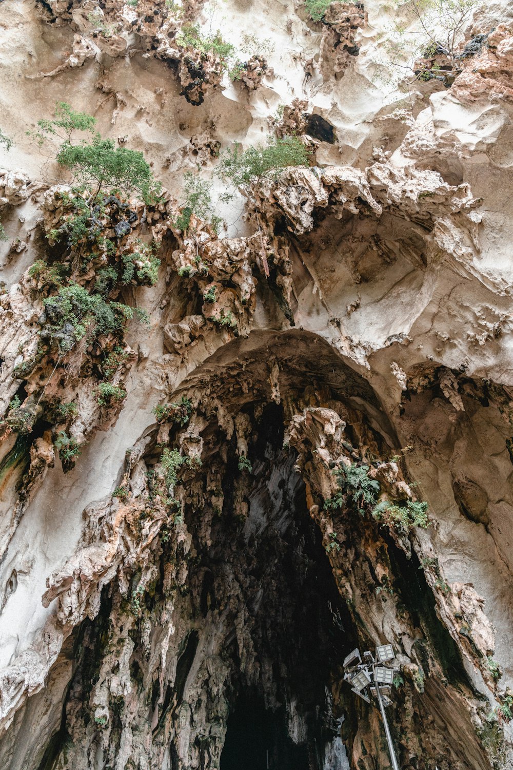 a rocky cliff with a hole in it