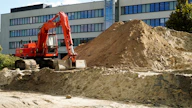 a construction vehicle in front of a building
