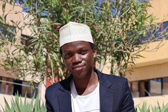 Model wearing a minimalist brimix cap outdoors on a sunny day, highlighting fit and style.