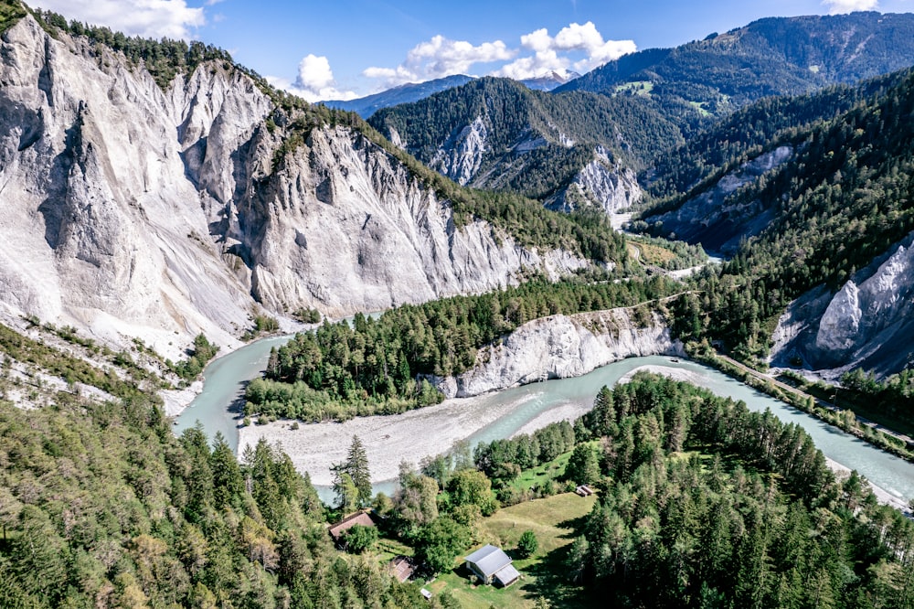 a river running through a valley between mountains