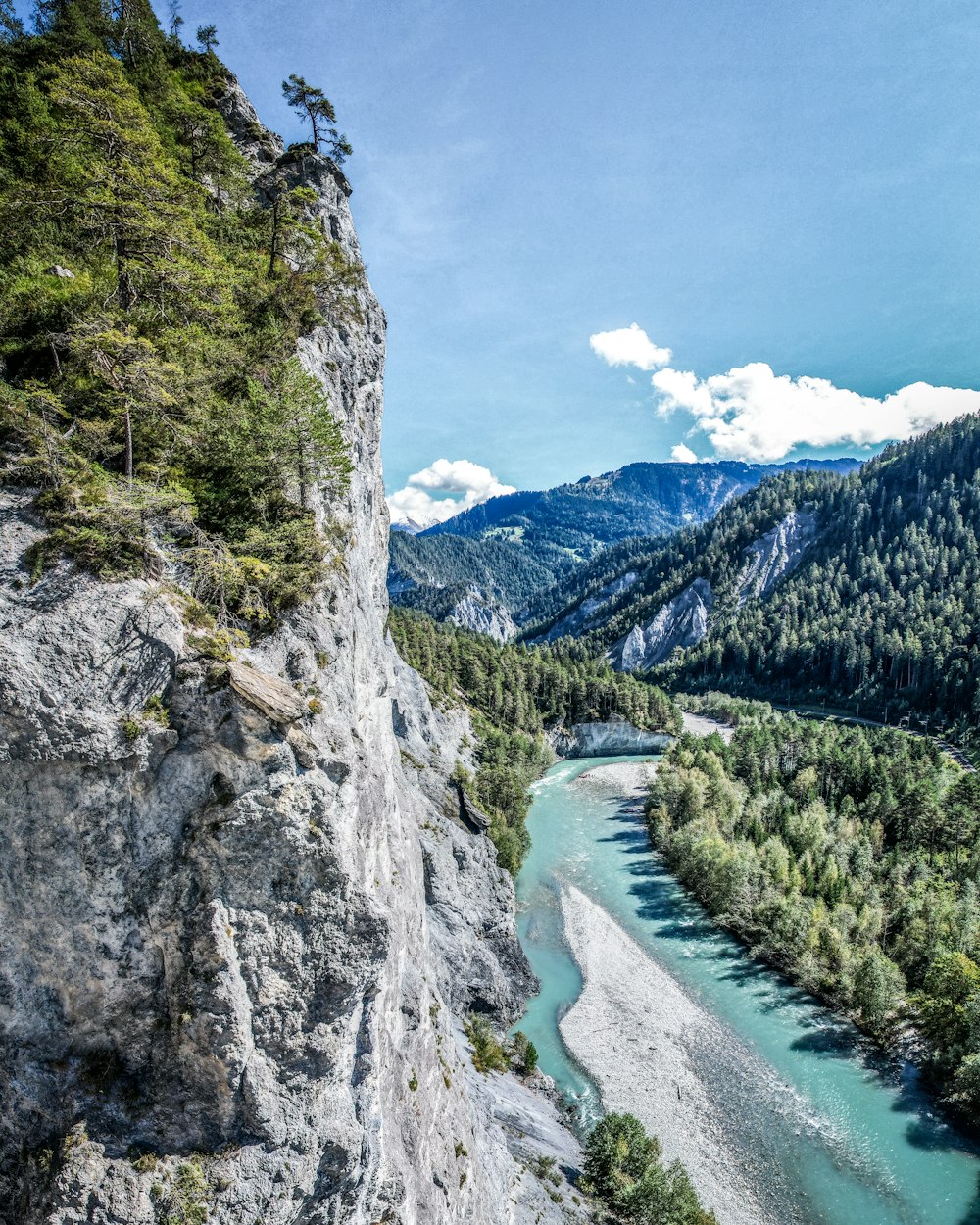 a river running through a valley between mountains