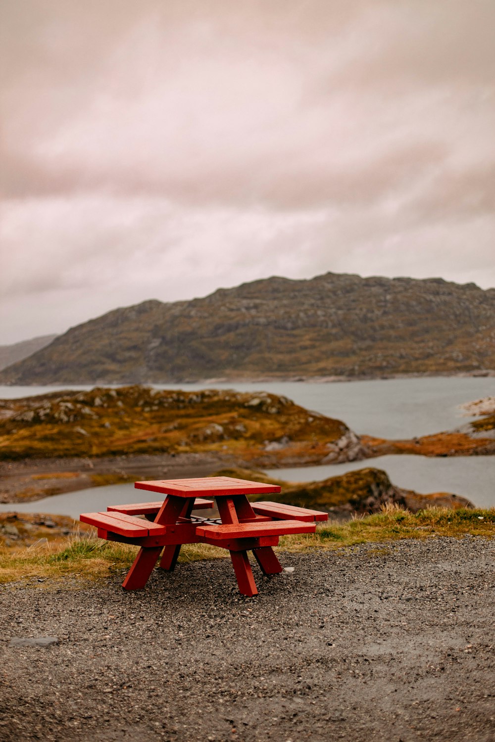 a picnic table on a rocky beach