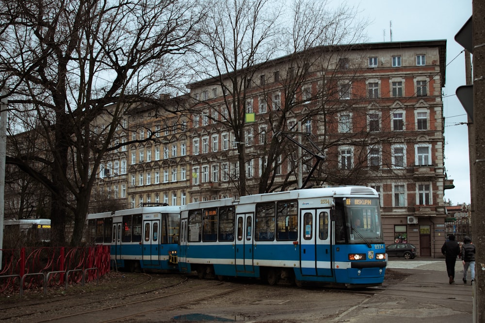 a blue and white trolley on the street