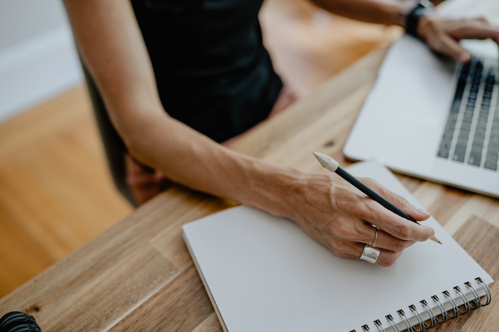 a person writing on a piece of paper