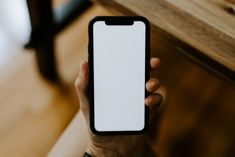 a person holding a white phone