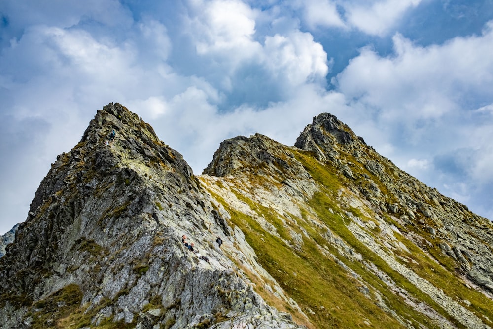 a rocky mountain with clouds