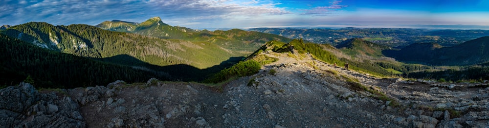 a rocky landscape with mountains in the background