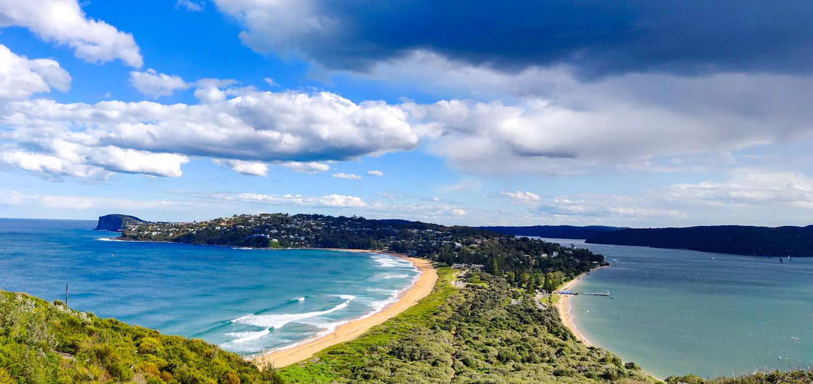 Aerial view north along the Northern Beaches coastline towards Palm Beach and Barrenjoey Lighthouse.