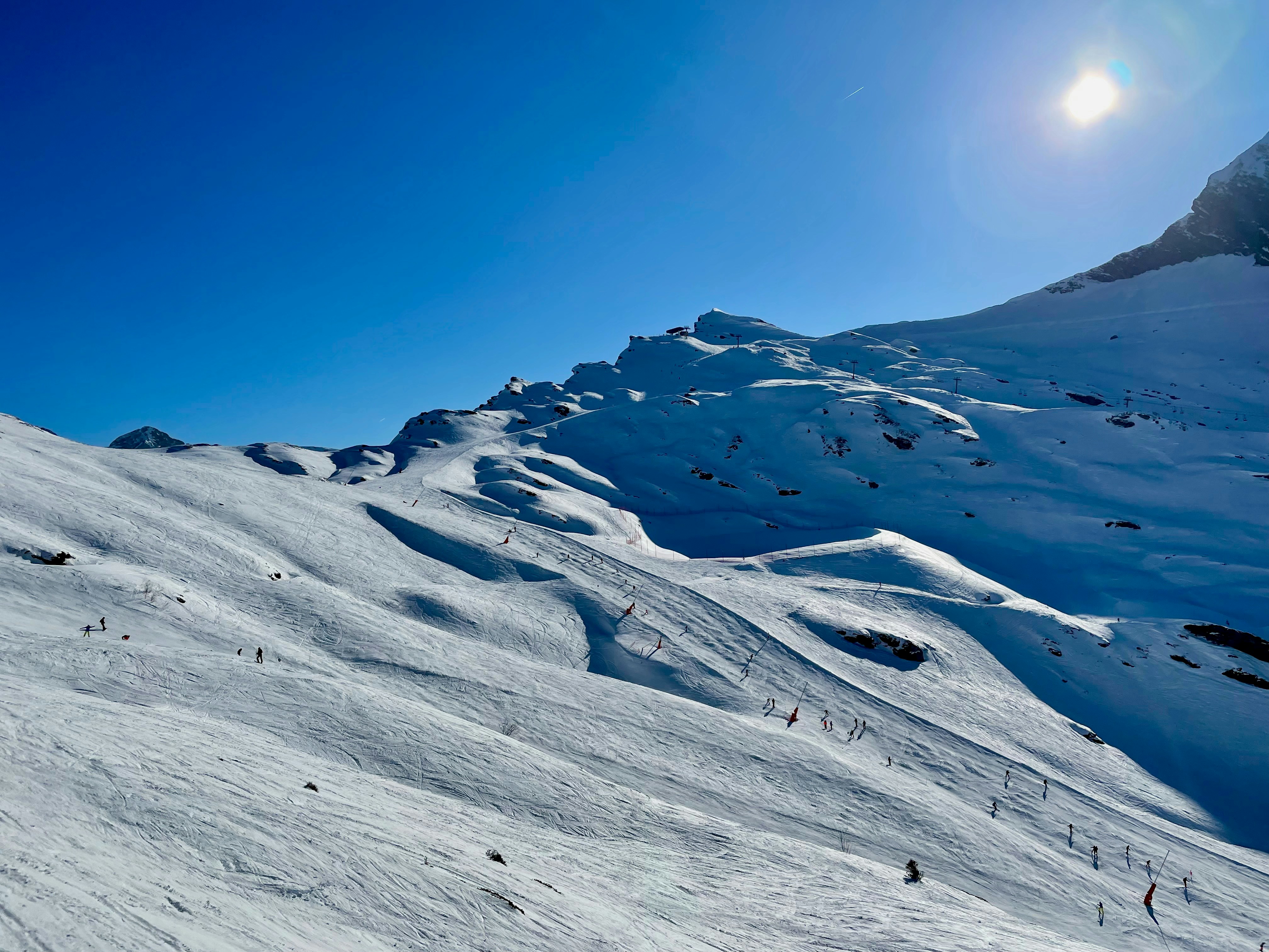 a snowy mountain with a blue sky, 
